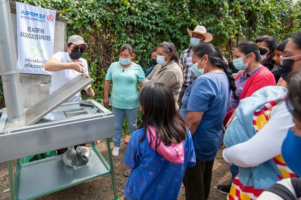 Community members in Mexico learn how to operate their new, cleaner-burning stoves